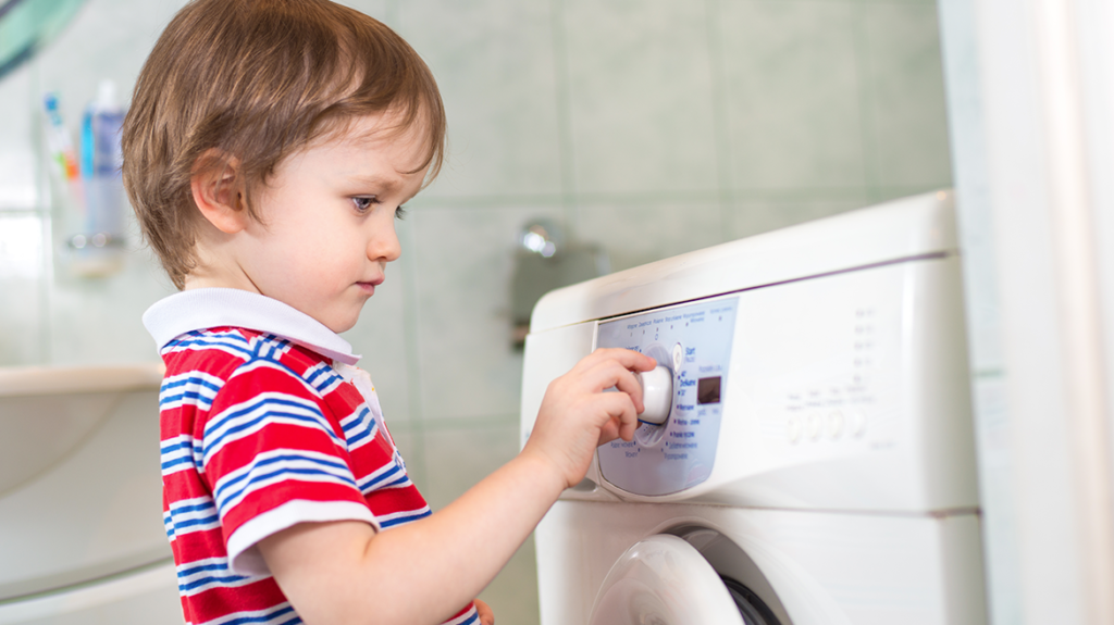 child doing laundry