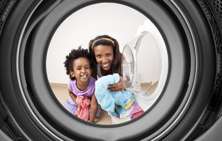 happy mother and daughter at the laundromat and kids