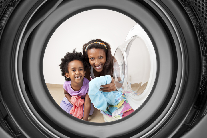 happy mother and daughter at the laundromat