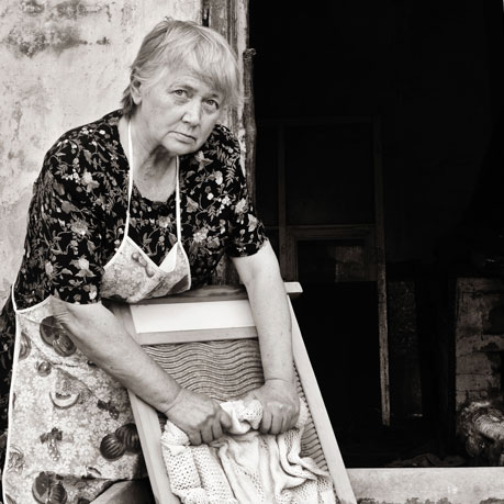 Woman doing laundry on a washboard