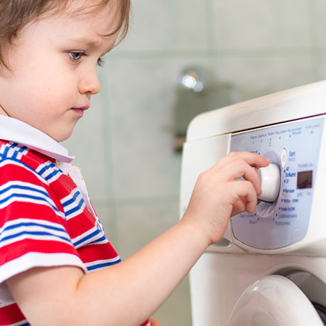 Kid starting a washer.