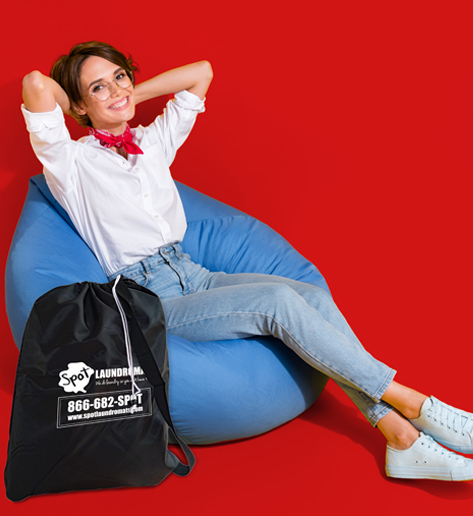 Spot laundromat laundry service happy woman with bag of laundry