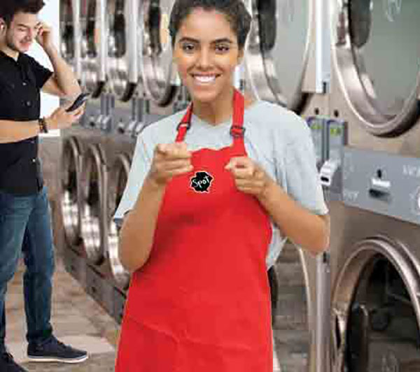 Spot laundromat attendant in front of our Huebsch stack dryers in our Frederick, MD location