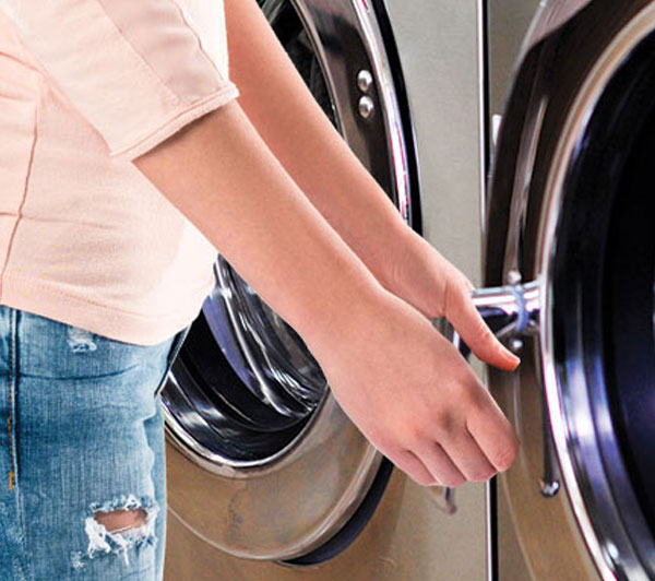 spot Laundromat Virginia Ave, Hagerstown, MD woman opening washer door