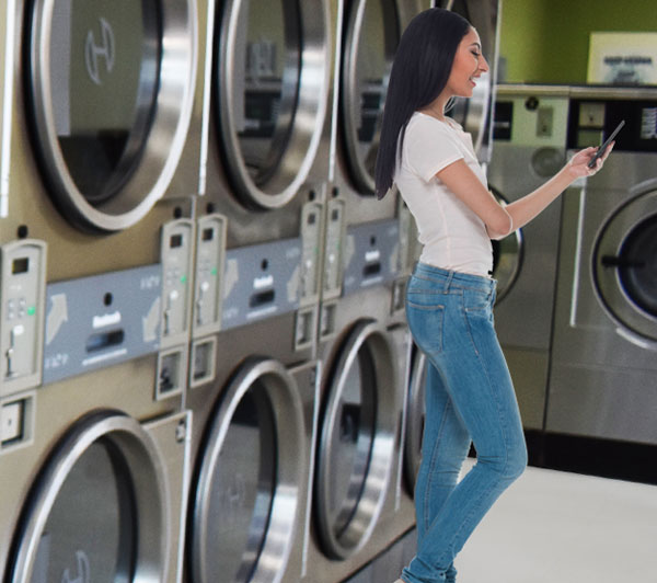 Woman using app at the Spot Laundromat On Willowdale Drive in Frederick, MD