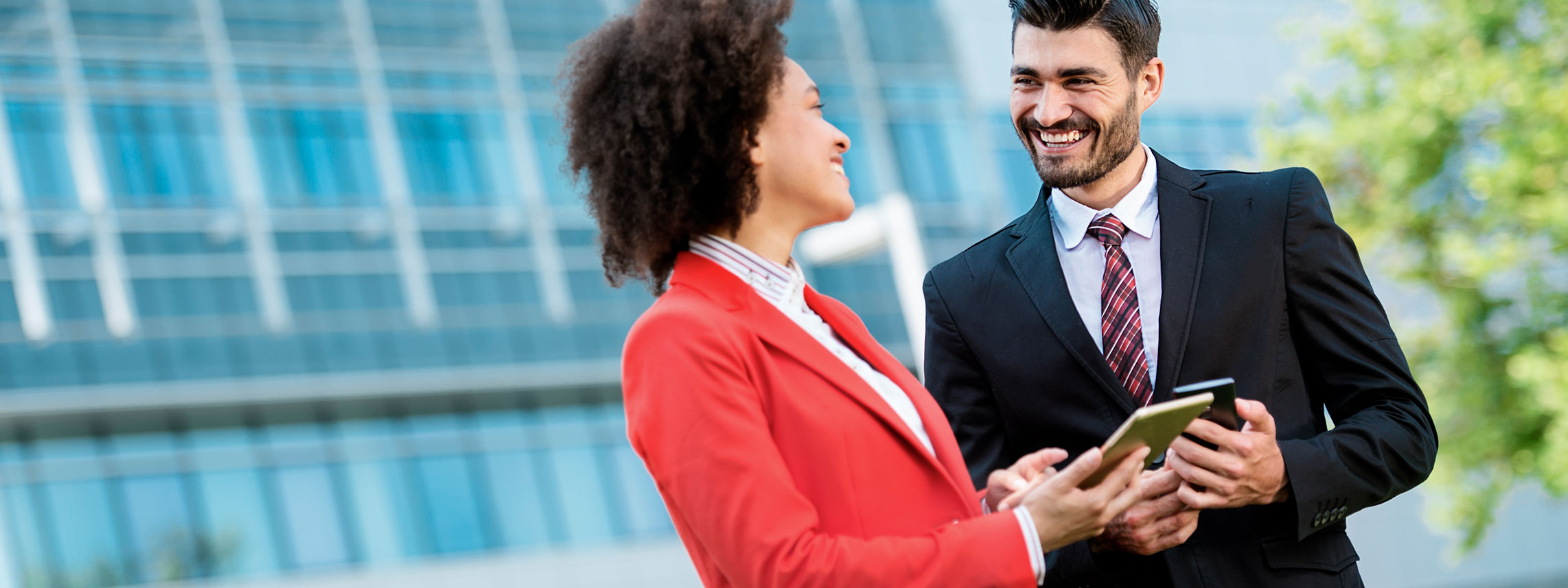 Dry cleaner happy business man and woman in dry cleaned clothes