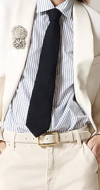 blue tie, brooch, white jeans and white belt